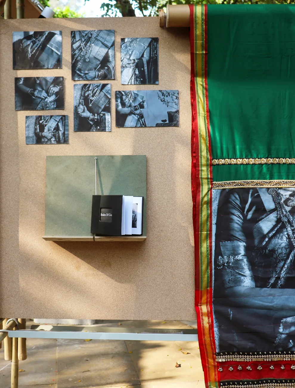 GOA FAMILIA - Exhibition display with vintage photographs and traditional Goan saree on cork board
